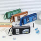 Assorted colors double-layer pencil cases with wrist straps on display.