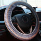Gray steering wheel cover with textured knit and multicolor zigzag seam