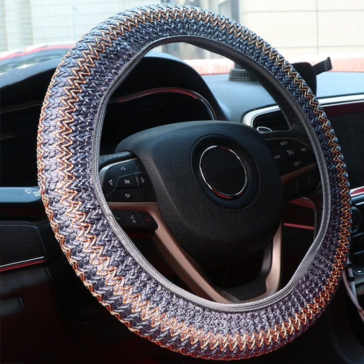 Gray steering wheel cover with textured knit and multicolor zigzag seam
