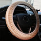 Beige steering wheel cover with braided knit texture and light-colored trim