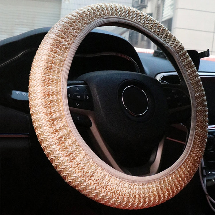 Beige steering wheel cover with braided knit texture and light-colored trim
