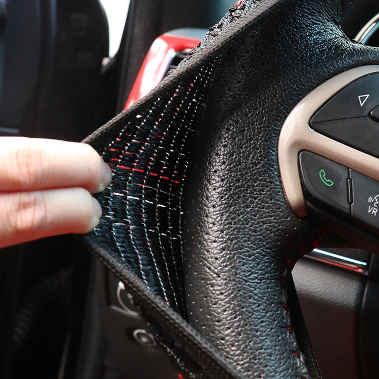 Steering wheel cover edge with red stitching on textured black fabric