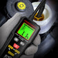 Close-up handheld brake fluid moisture tester showing green screen reading in gloves