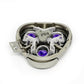 Inside of shaver replacement head showing purple rotors and white plastic parts