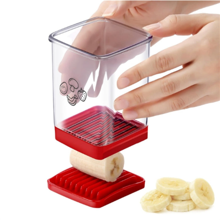 Fruit and vegetable slicer with clear container, red base, and push plate held by hands