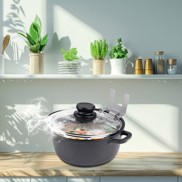 Stainless steel lid holder clip holding a pot lid on the stove