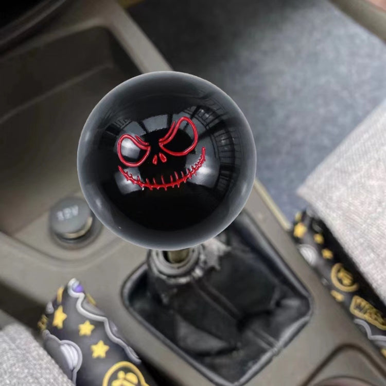 Black spherical shift knob with red-and-white ghost face graphic