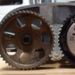 Engine timing gears with metal camshaft holder tool near sprockets