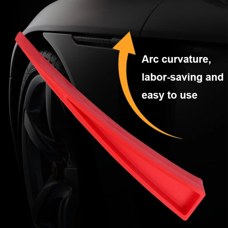 Red plastic dent repair support clip on car wheel area, long wedge tool