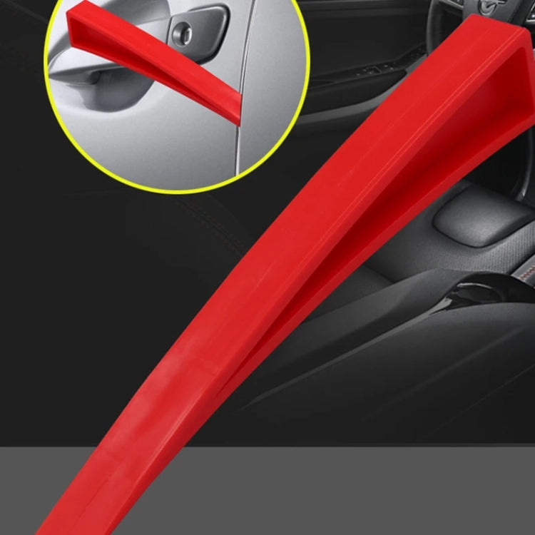 Red plastic dent repair support clip on car door panel, long wedge tool