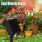 Solar watering device on stand beside potted plants with connected hoses