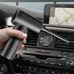 Wireless handheld vacuum air pump being used near car dashboard vents
