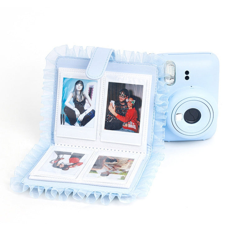 Blue lace mini camera photo album open, showing two photos and ruffled pages