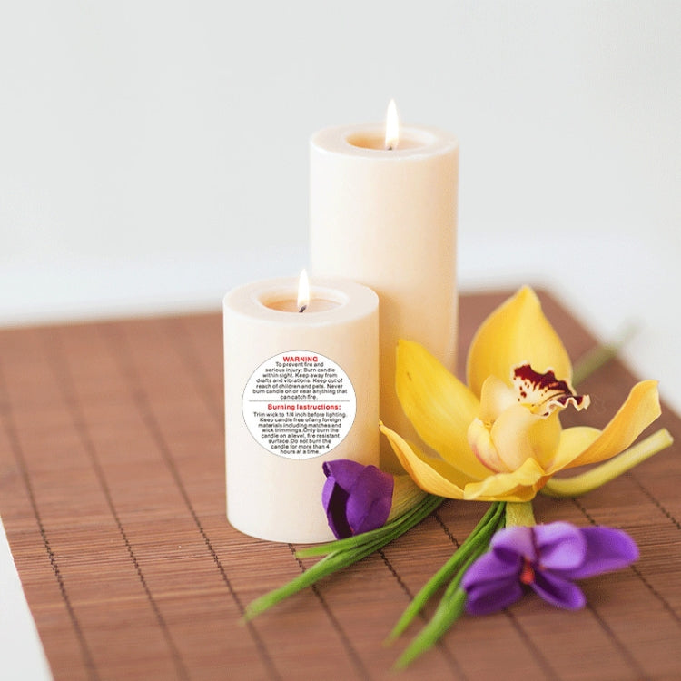 Round warning label sticker on candle, white label with red WARNING and instructions