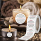 Warning label sticker strip with red WARNING text beside lit candles