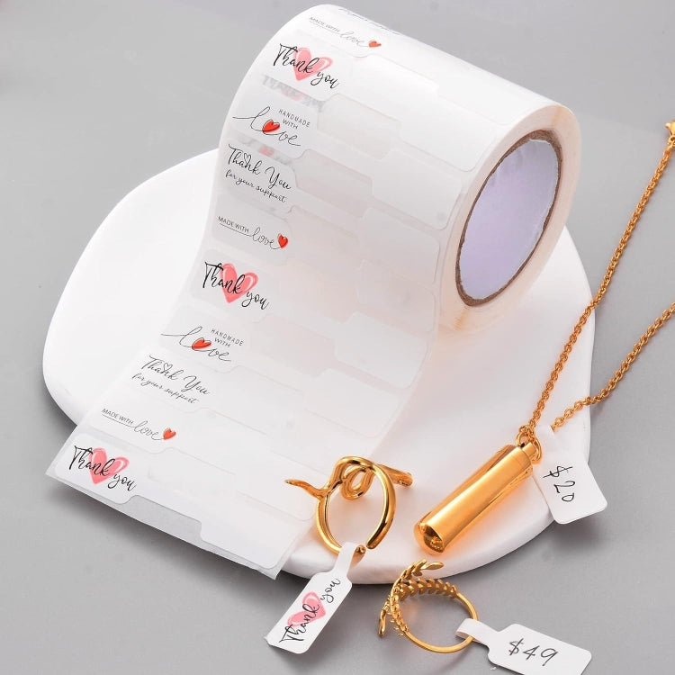 Roll of white thank you stickers with red heart accents