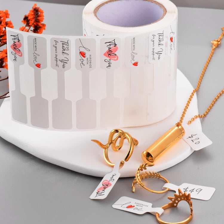 Roll of thank you stickers with red hearts and matching label pieces