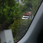 Window sticker on car windshield reading “NEXT SERVICE DUE” with date and miles