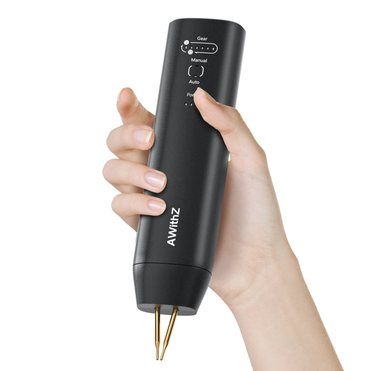 Handheld spot welding machine in use, fingers on control buttons