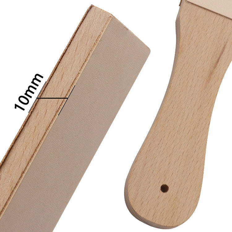 Close-up of double-sided leather sharpening board with wood handle and tapered ends