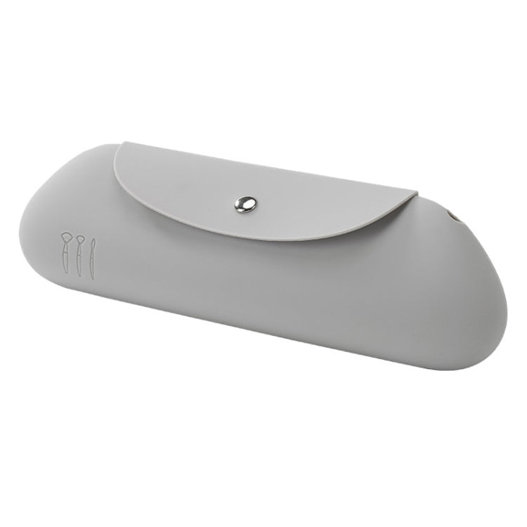 Light gray silicone makeup brush storage bag with snap button closure, curved shape