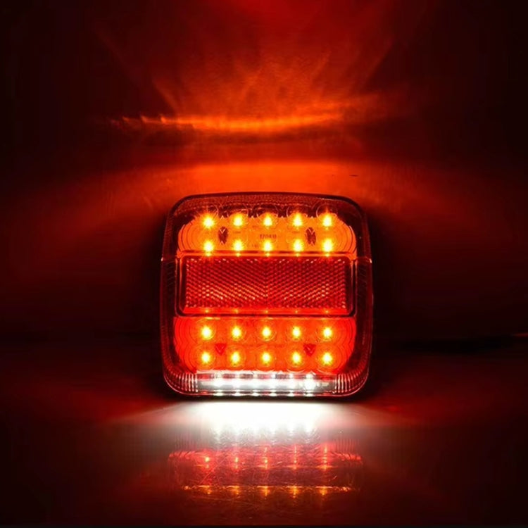 Lit square LED trailer brake tail light showing amber and red LED glow