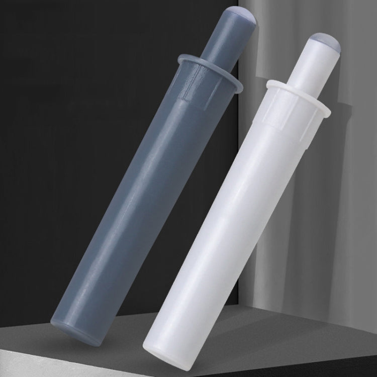 Cabinet door dampers, one gray and one white, mounted on cabinet panels