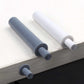 White and gray cabinet door dampers installed along cabinet edge with bumper pads