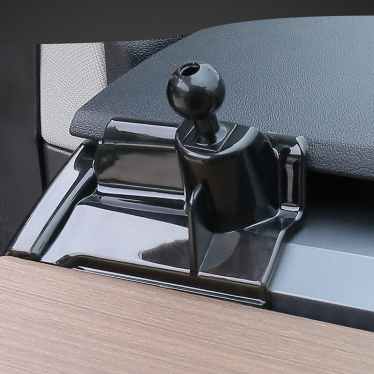 Black phone holder base with ball joint clamp gripping a dashboard outlet