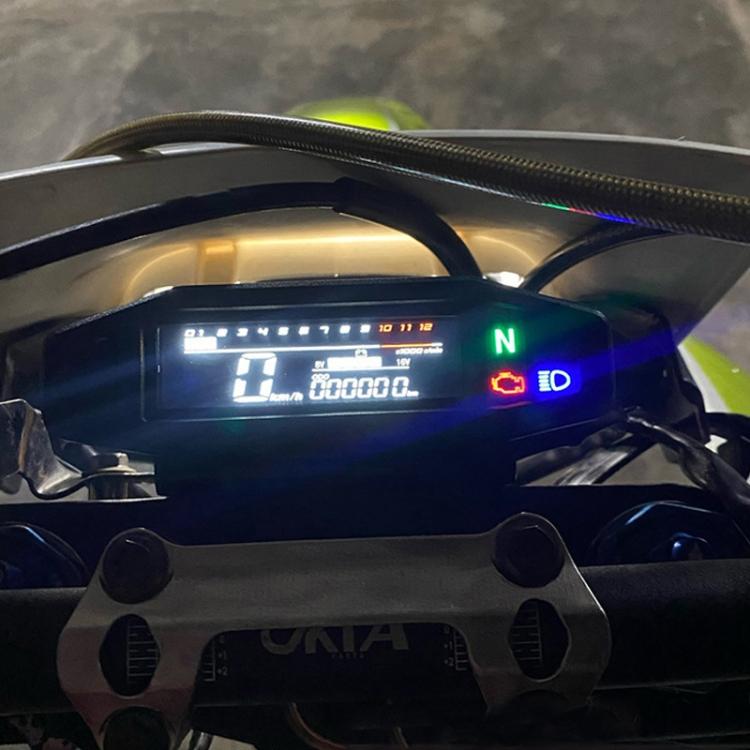 Motorcycle LCD instrument cluster installed on bike, showing neutral and digital readouts