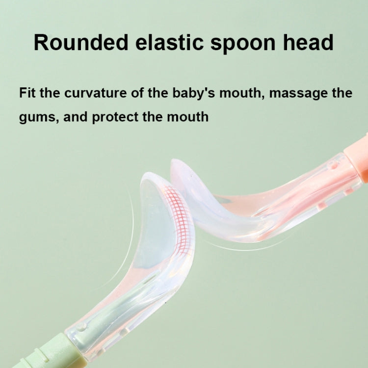 Baby food spoon close-up: translucent flexible spoon head with rounded edge, on pink handle