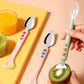 Double-head baby food spoon set with pink and green handles, stainless serrated scoops