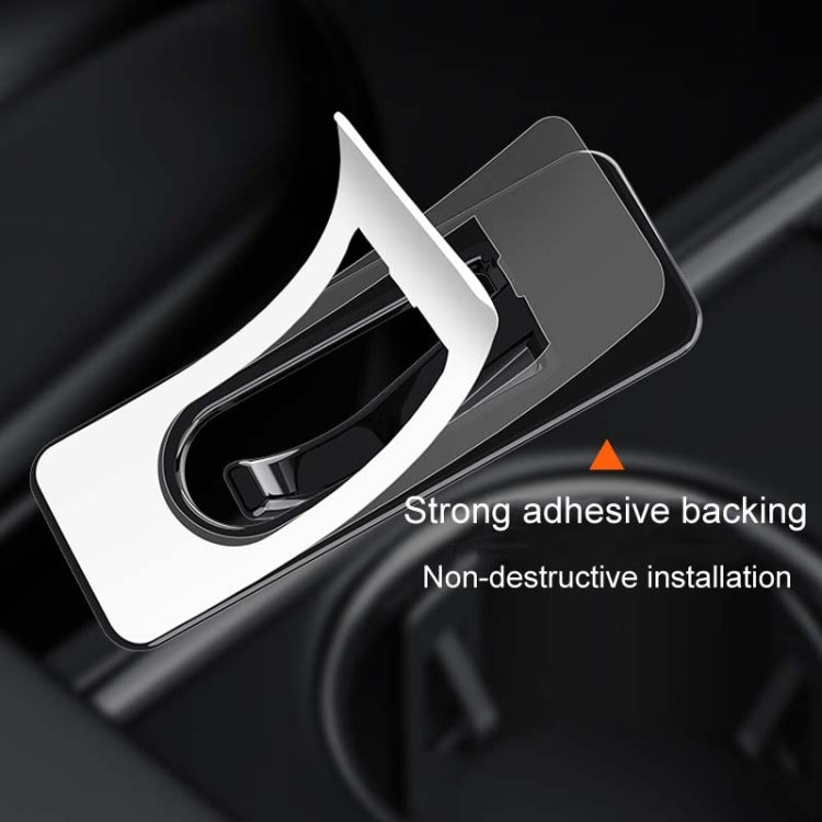 Cup holder limiter piece with adhesive backing and clip-style loop for mounting