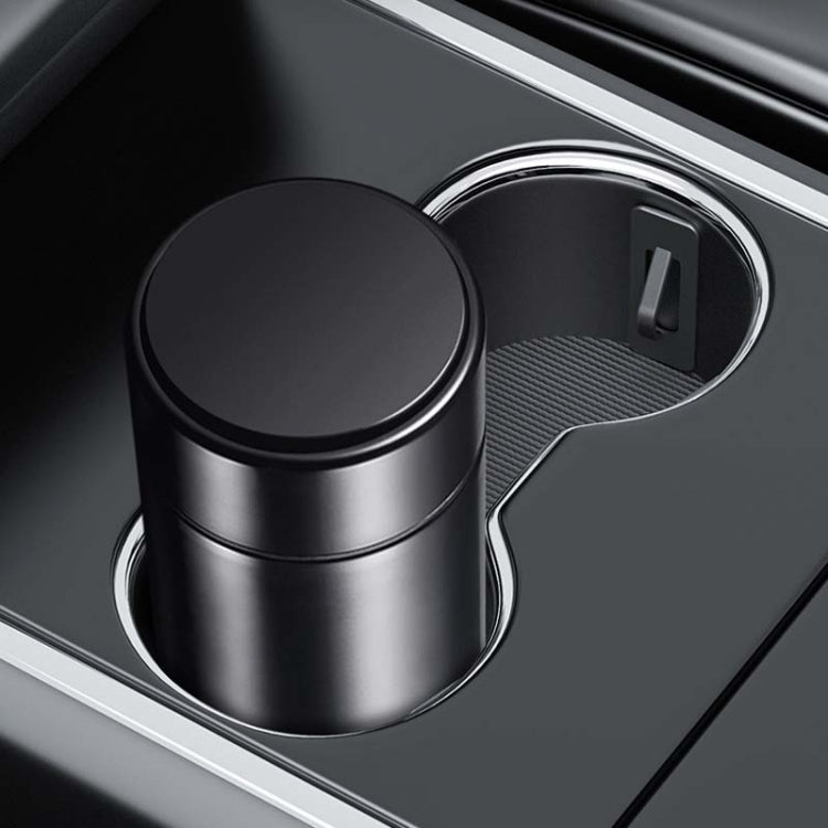 Installed cup holder limiter with textured mat holding a metal cup