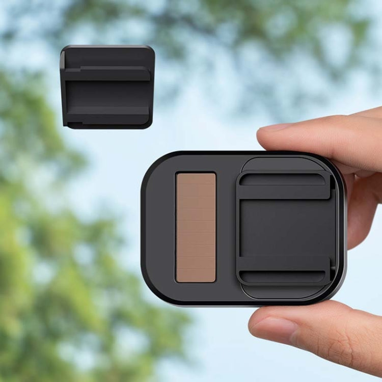 Black ETC slide bracket with device holder and sliding cover, held in hand