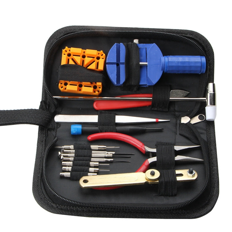 Watch repair tool kit in black zip pouch with orange parts and red-handled tools