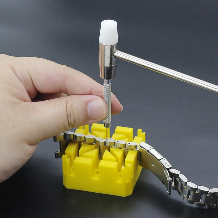 Watch bracelet pin tool removing a pin above a yellow holder
