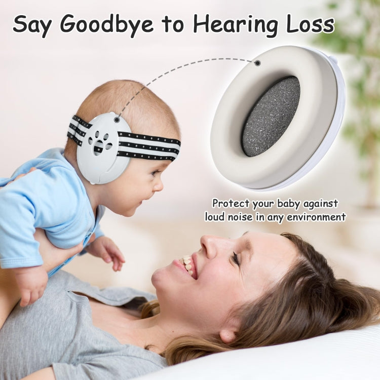 Baby wearing white and black striped earmuff headband with padded ear cups