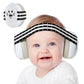 Baby close-up wearing white earmuff ear cups with black striped headband