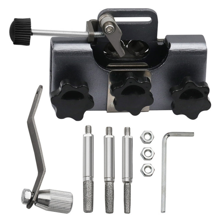 Black handheld chain sharpener with three grinding heads and crank handle.