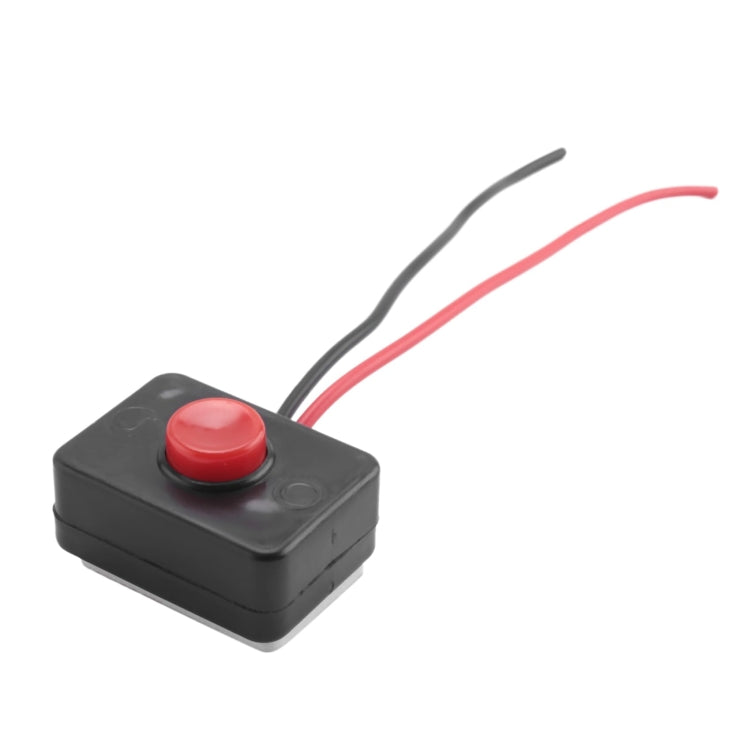 Black push-button switch with round red button and attached red/black wire leads