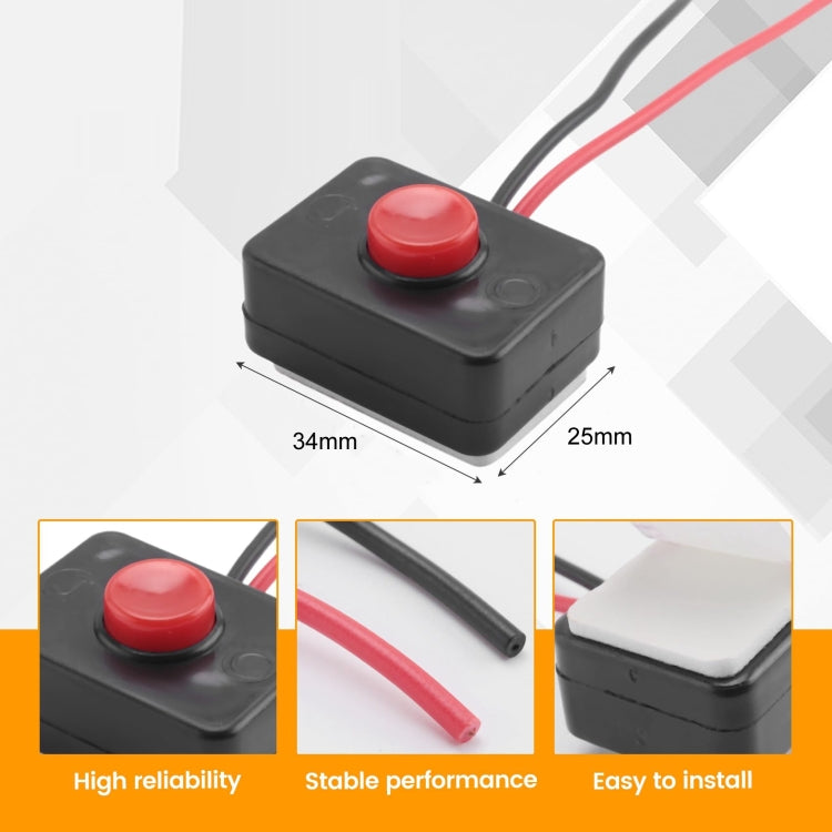 Black push-button switch with red button and two wire leads, compact rectangular body