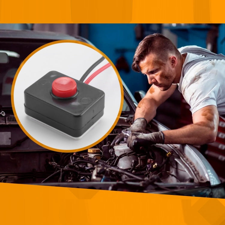 Black push-button switch with red button inset above open engine bay