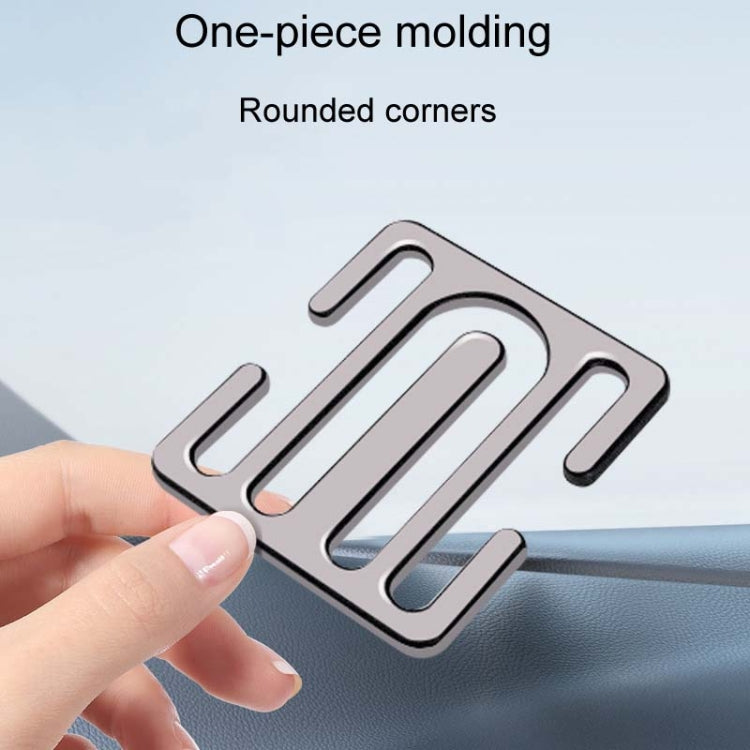 Silver metal seat belt limiter plate with rounded corners held by hand