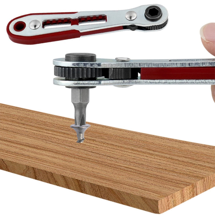 Ratcheting socket wrench driving a screw on a wooden board, red and silver