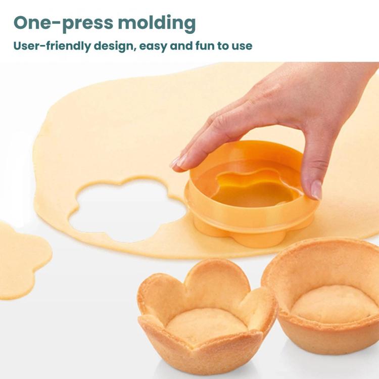 Orange heart-shaped cake cup press mold with hand pressing dough into cup