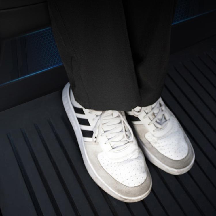 Black rear seat anti-kick pad protecting the area under shoes on the back floor
