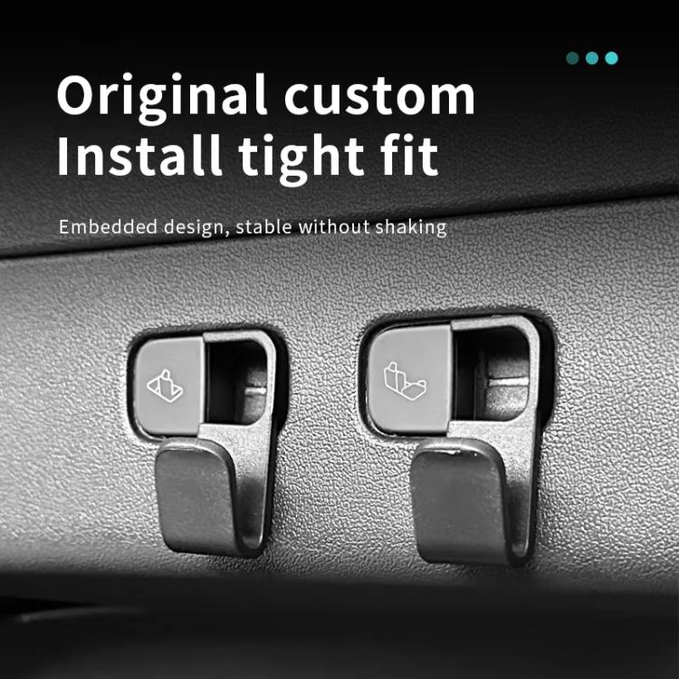 Pair of black embedded trunk hooks on car interior panel with hanging clip