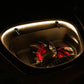 Open car front trunk with warm LED light bar glowing around the interior perimeter