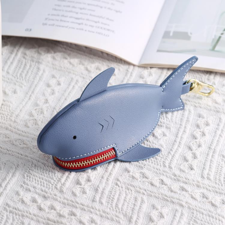 Dark blue shark-shaped key protective cover with gold ring and red zipper